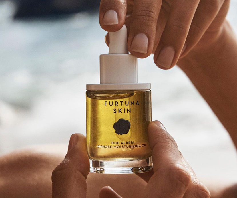 Woman holding a bottle of biphase moisturizing oil