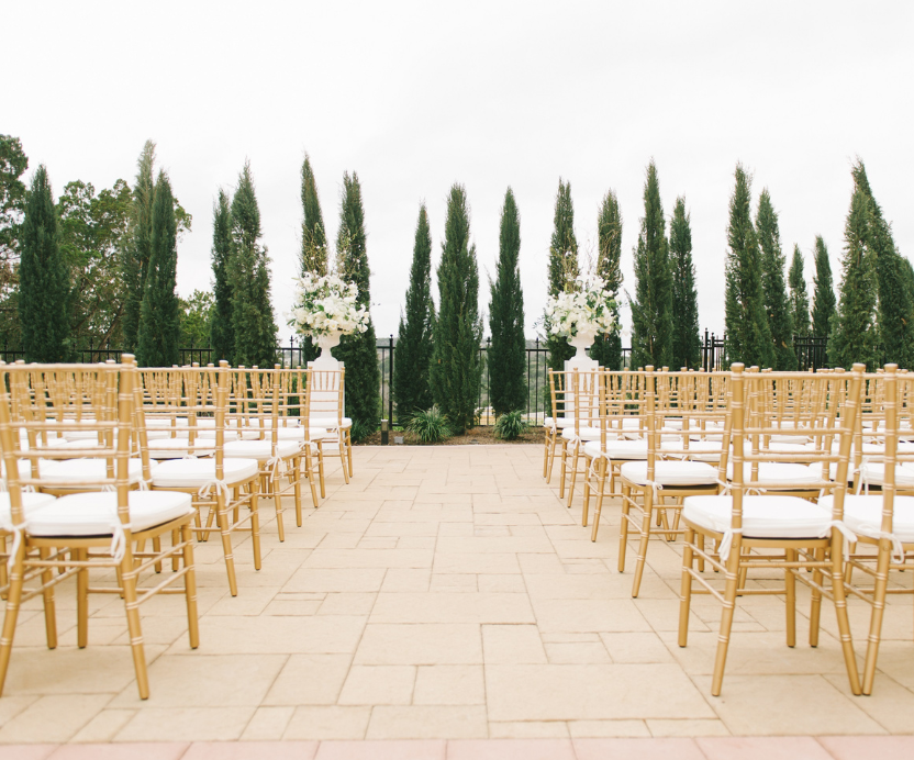 Several gold and white chairs lined up