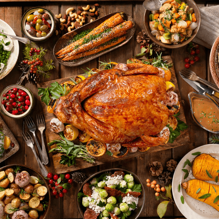 An entire cooked turkey surrounded by various dishes