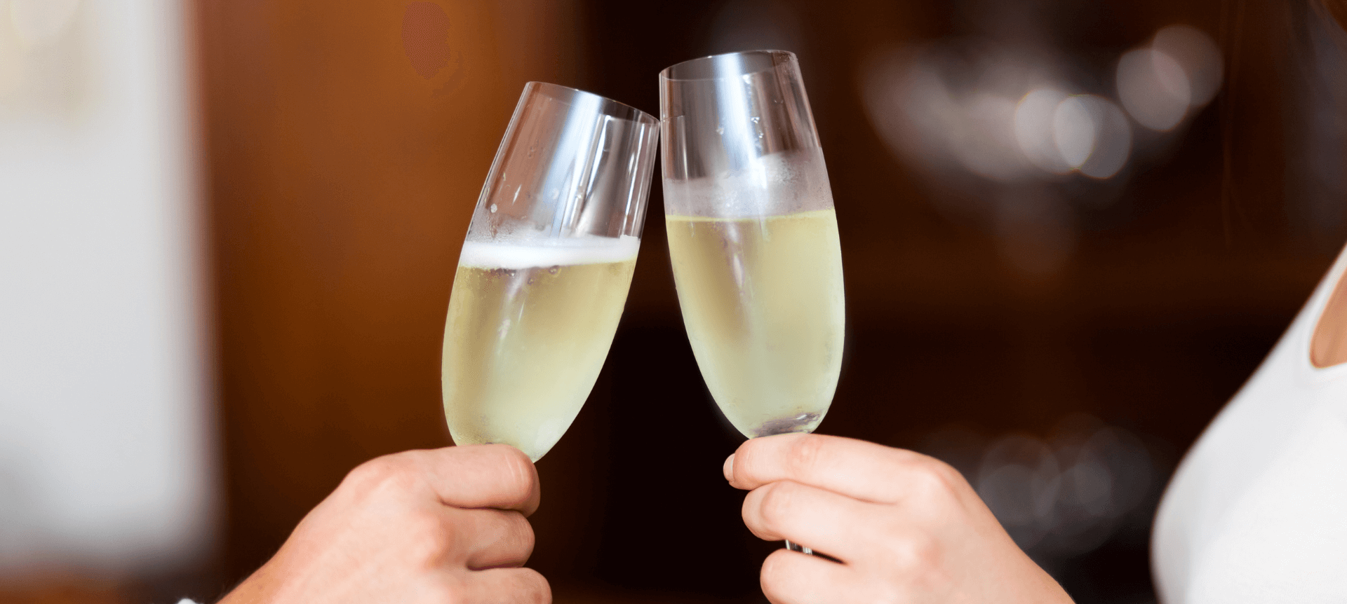 Two people toasting with champagne glasses 