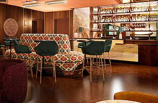 Internal view of a bar full with colorful furniture and a variety of drinks