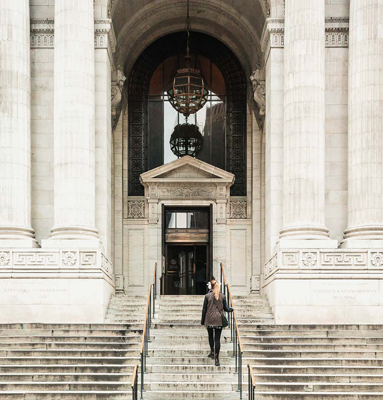 woman walking up the stairs at the museum