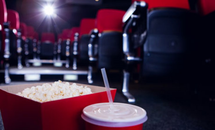 movie theatre seats with popcorn and soda