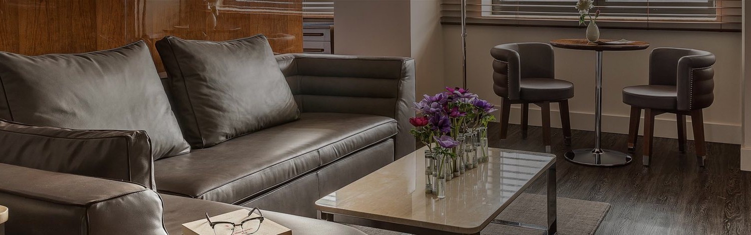 a seating area with fresh flowers on the table