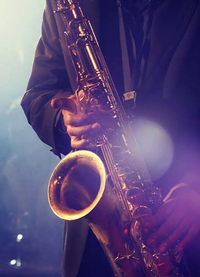 Close up of a man playing saxophone at a jazz gig