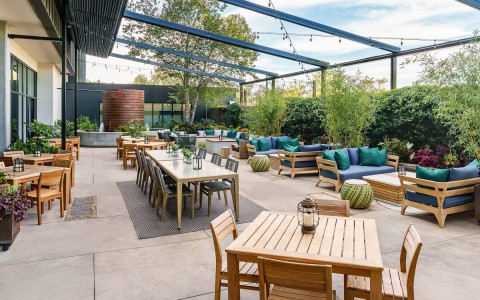 Cozy courtyard seating area with bunch of different tables at daytime