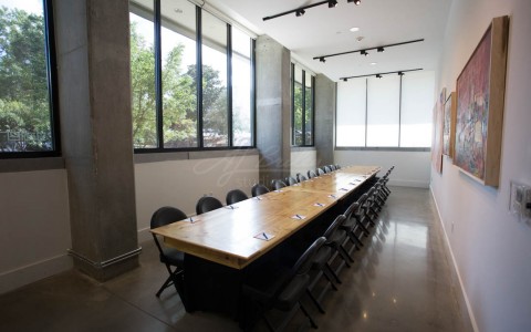 Big rectangular wooden table set up for a meeting  