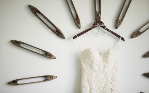 wedding dress on a hanger on a wall