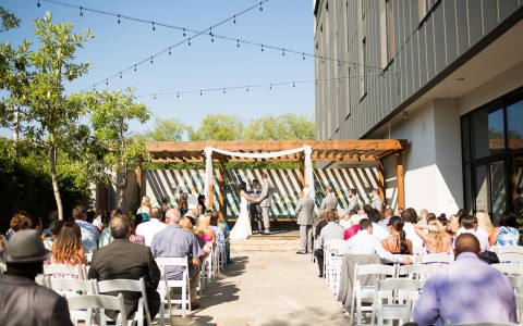 outdoor wedding ceremony with guests watching bride and groom get married