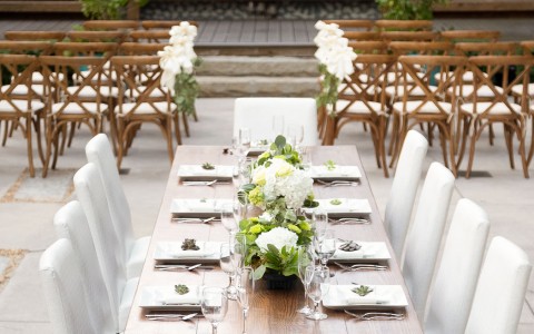 long banquet table set outdoors in the couryard