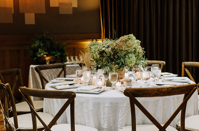 wedding reception banquet table with place settings and a centerpiece