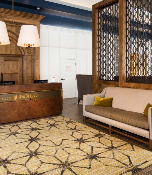 Lobby area with rug and wooden front desk