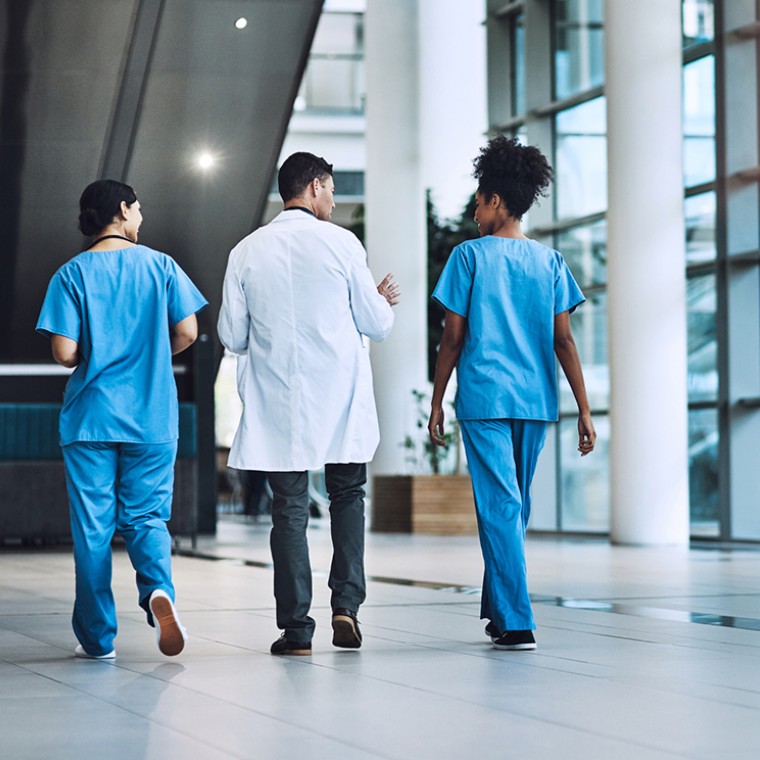 Doctor walking with two nurses