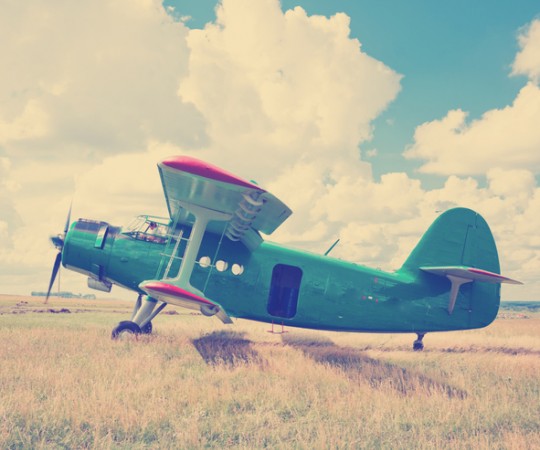 vintage prop plane in field