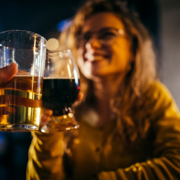 two people having beer in a dim bar