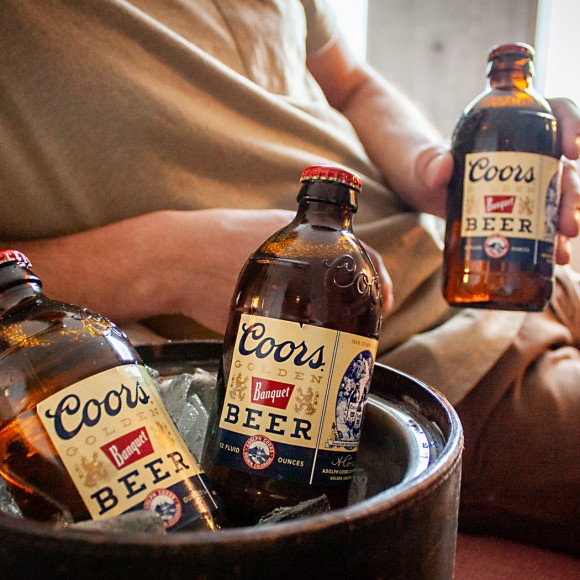 ice bucket with two brown coors beer glass bottles 