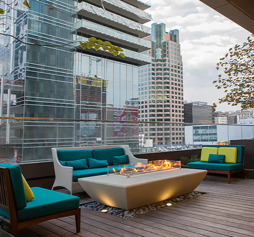 View of a terrace with a big fireplace and some sofas