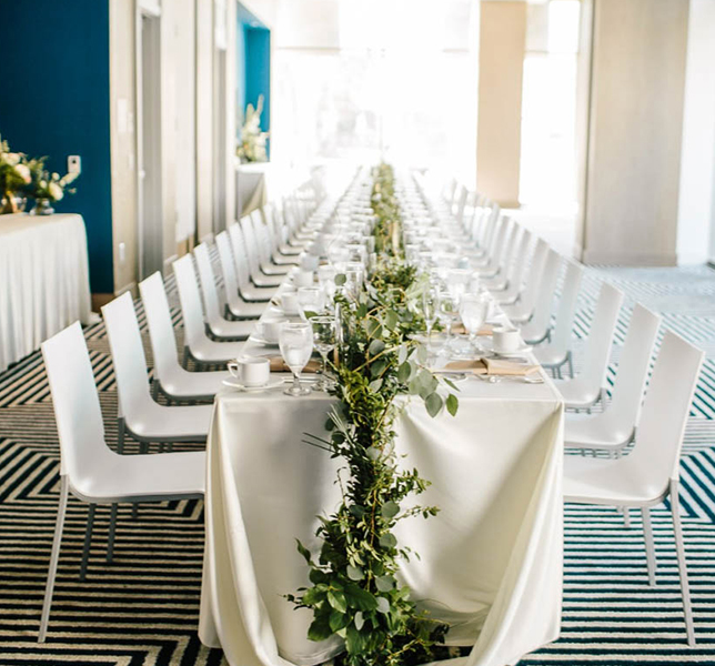 View of a large white table with wedding decoration 