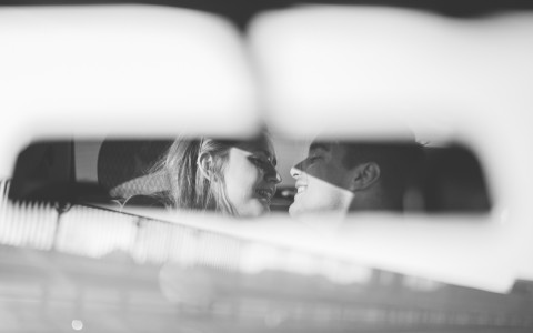 a couple in a car kissing