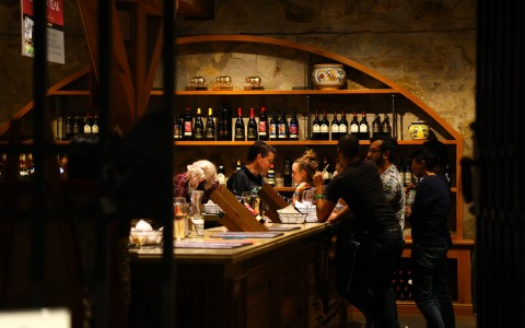 a peek inside winery shop with guests in background 