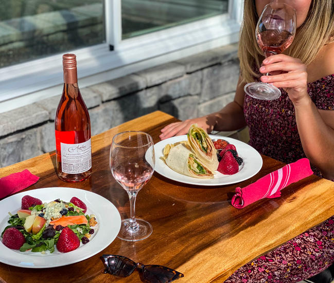 woman drinking wine with her wrap