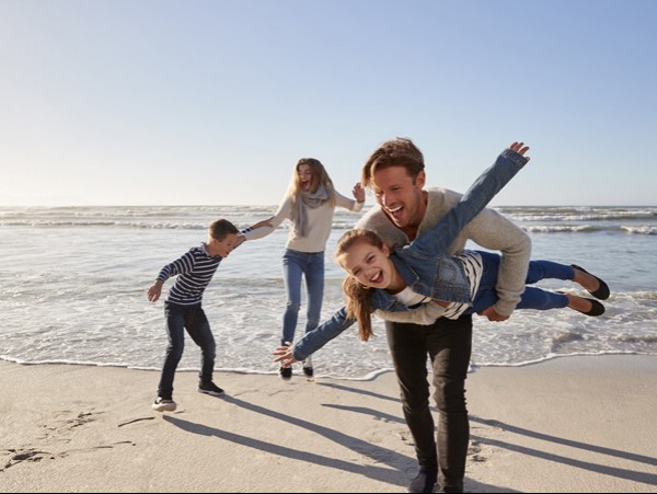 family playing on beach