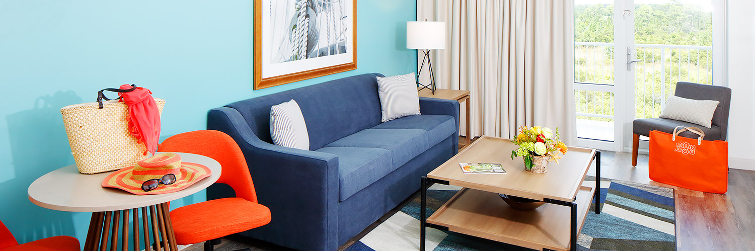 a blue couch in the sitting area of a guestroom