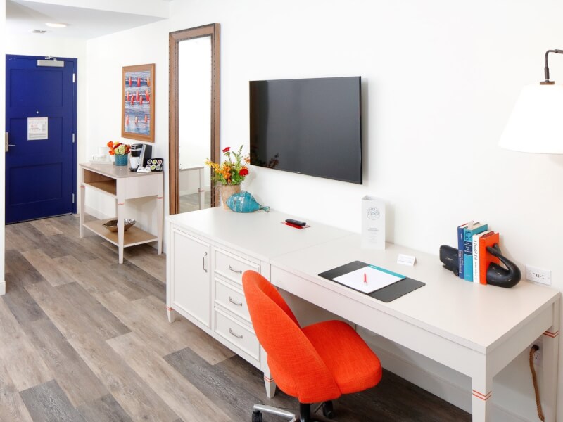 desk space and tv on wall in guest room