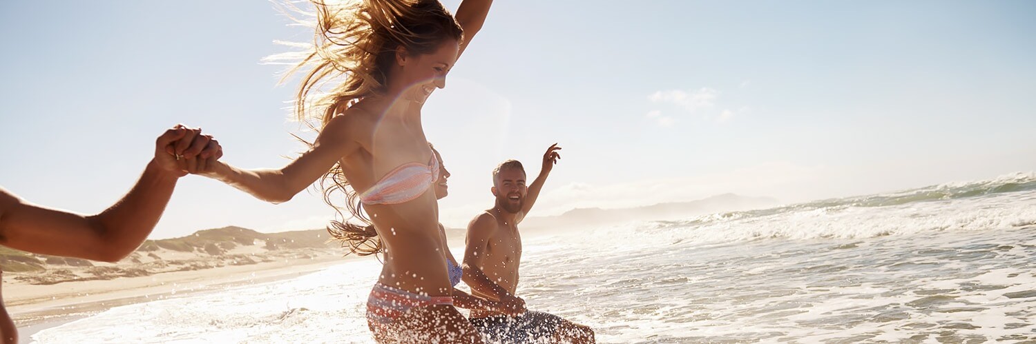 couple playing in surf at the beach together