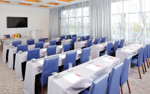 meeting space setup for classroom setting with rows of tables and chairs