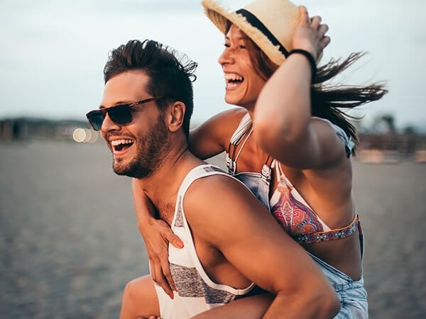 couple laughing together on the beach