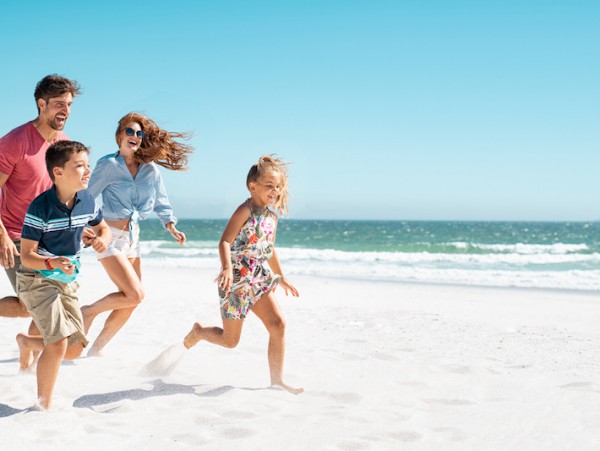family running on the beach