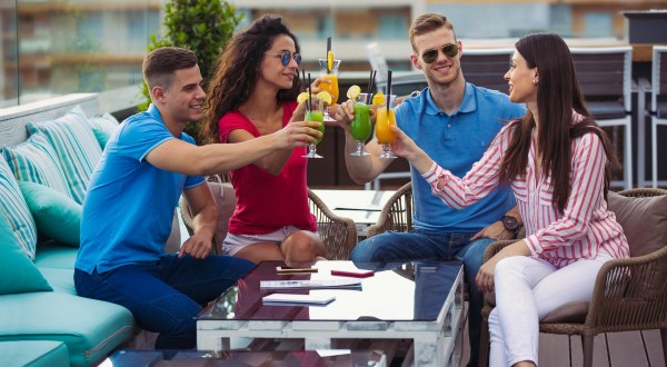 people with drinks at outside lounge area