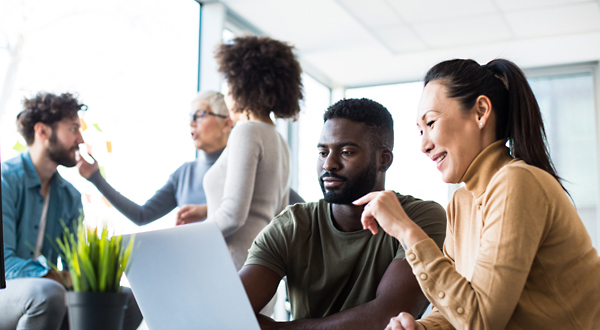 a group of coworkers, working together in a shared meeting space