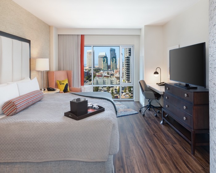 hotel room with king bed and city view