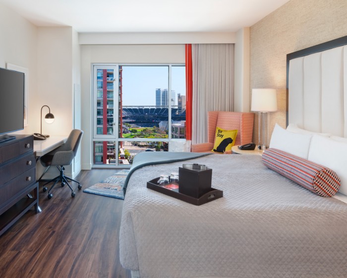 guest room with king bed and view of petco park stadium