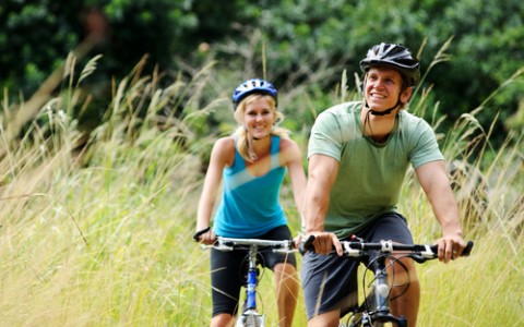 couple riding bicycles outside