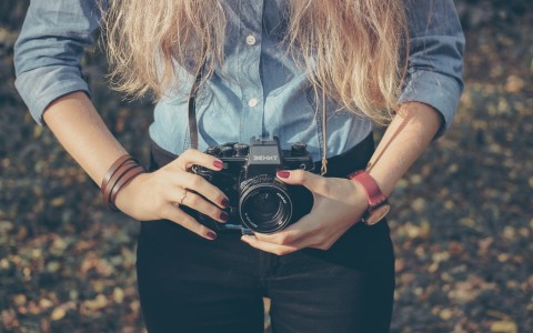 girl holding camera