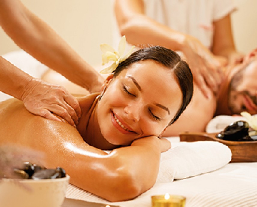 woman getting aback massage while smiling