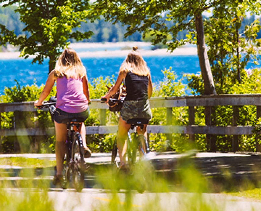 2 women biking on a sunny day