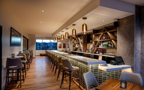 seating along bar and hightop tables against walll