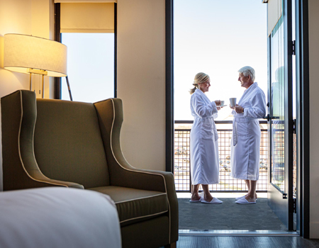 couple on balcony in hotel room