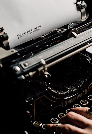 person typing on typewriter machine