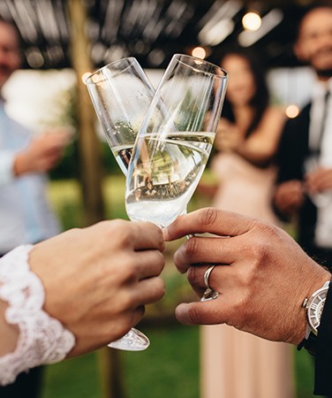 two wedding people toasting with champagne