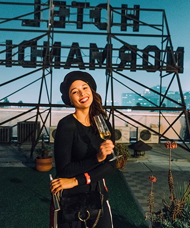 woman drinking champagne on hotel rooftop