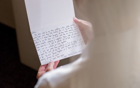 close up of a person reading a hand written letter 