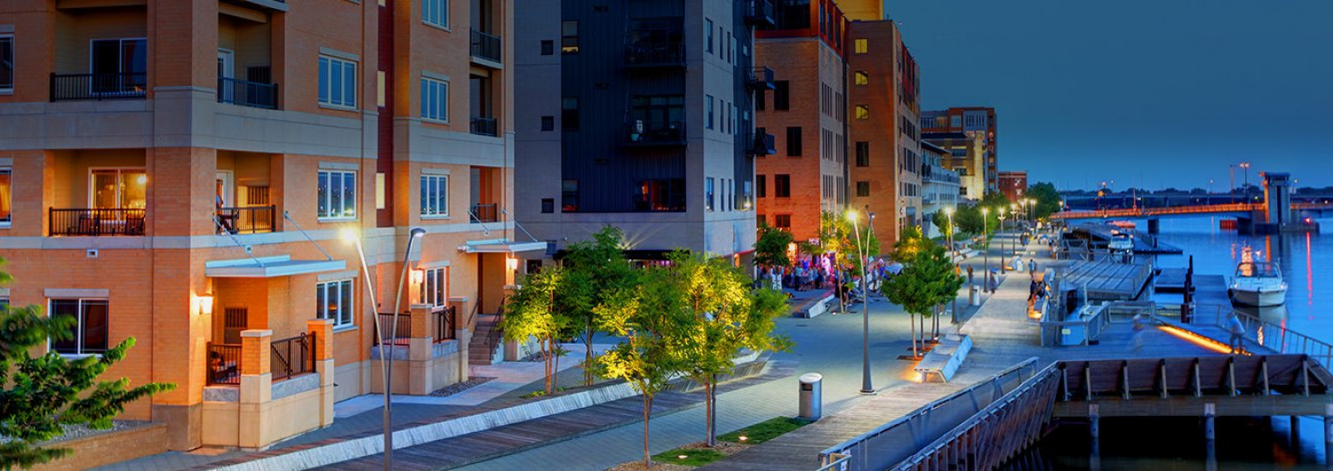 hotel building along a pier near the water lit up at night