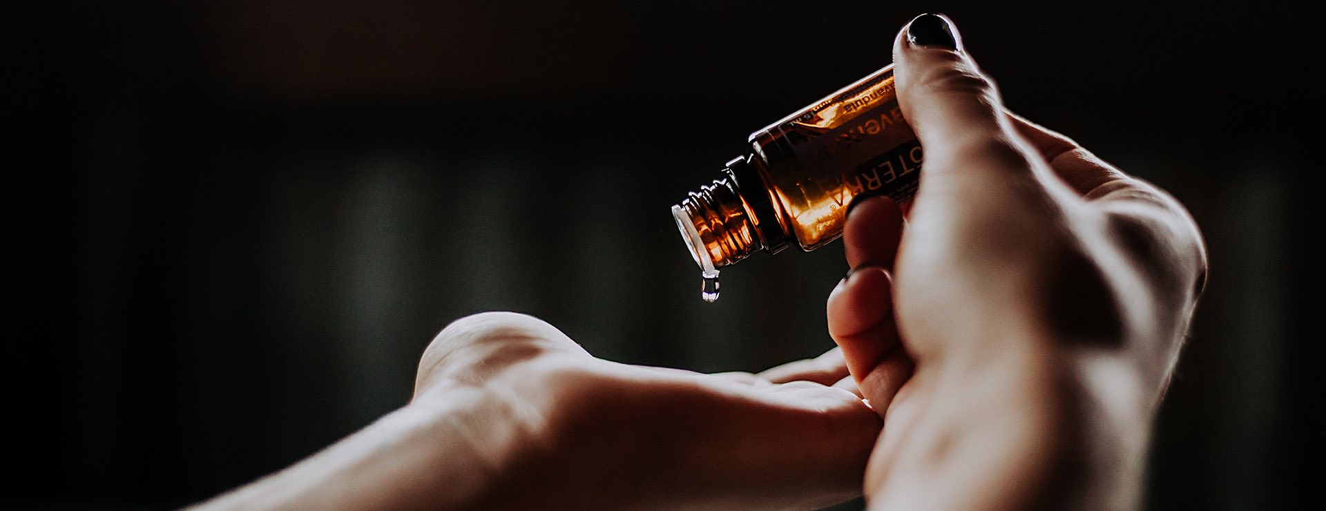 hand pouring oil into another hand