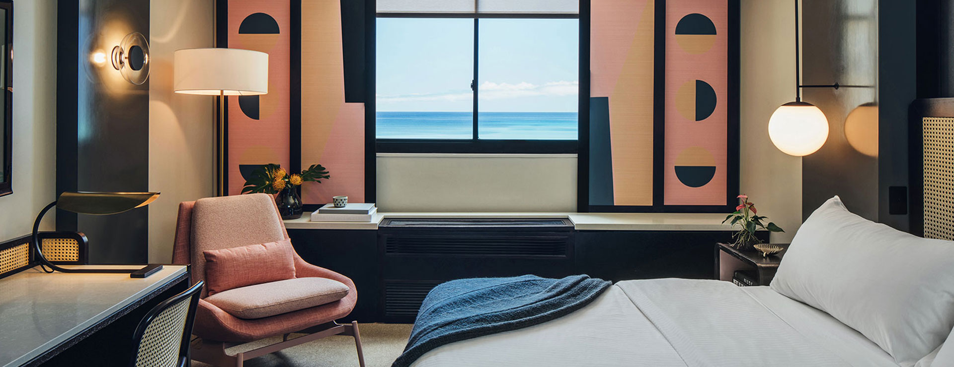 guest room with pink chair and pink window shades