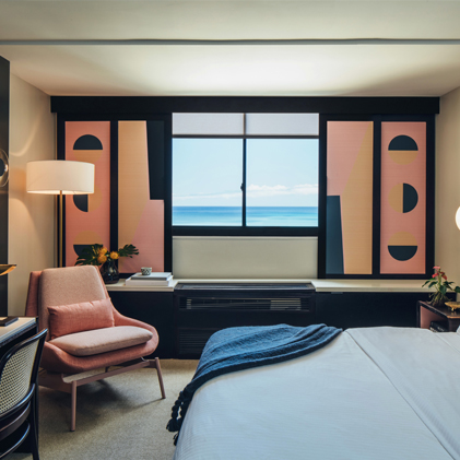 room with ocean view and pink window shades